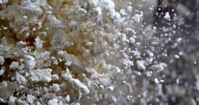 Slow Motion Close Up Flour Powder Explosion On Black Background With Flying White Particles. Baking Ingredient Cloud, Abstract Food Texture, Dramatic Cinematic Dust Burst