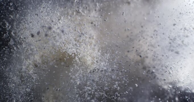 Slow Motion Flour Powder Explosion On Black Background With Flying White Particles. Baking Ingredient Cloud, Abstract Food Texture, Dramatic Cinematic Dust Burst