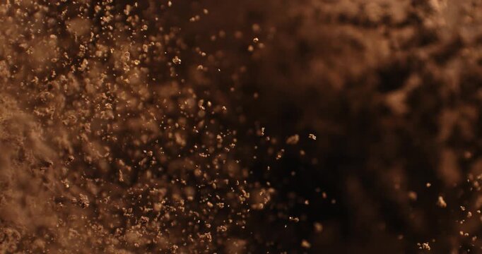 Slow Motion Coffee Powder Cloud Rising On Black Background. Ground Coffee Dust Explosion, Aromatic Texture And Cinematic Particles