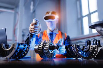 Young caucasian male engineer using vr technology for simulated turbine assembly in industrial setting
