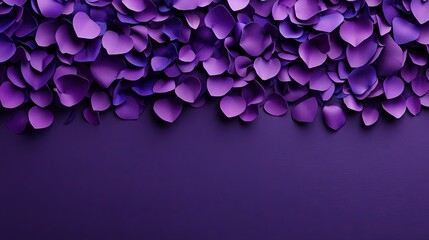 Fototapeta premium A collection of purple paper flowers or petals arranged densely on a dark purple background, creating a decorative and artistic pattern