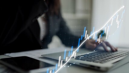 A focused professional analyzes market trends using a laptop and smartphone in a sleek modern office, showcasing financial growth and data-driven decisions. Copula