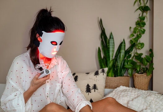 Woman using Led Light Facial Mask Treatment
