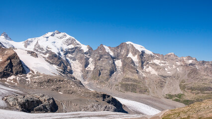 Stunning panoramic view of snow-capped peaks in Bernina range and the melting Pers Glacier in Swiss Alps
