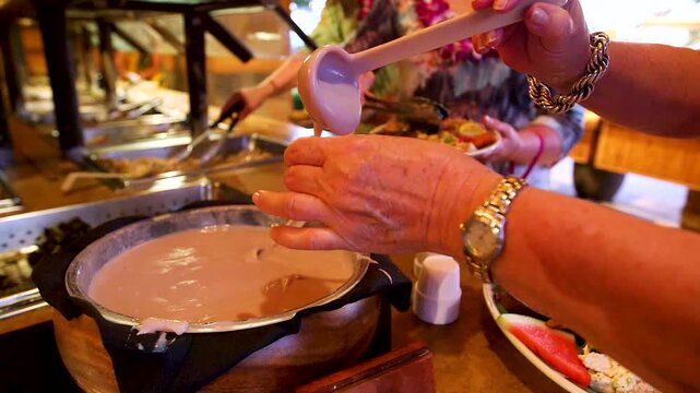 Man eating poi at hawaiian luau