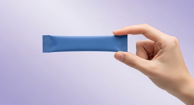 Hand Holding Blank Blue Stick Pack Mockup on Soft Lavender Background