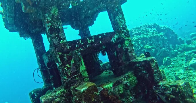 Mysterious ancient underwater temple altar ruins covered in coral and marine life, drifting in deep blue water. Cinematic slow motion dive scene for travel and exploration.
