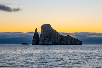 Cruise ship and Kicker Rock at sunset, San Cristobal island, Galapagos national park, Ecuador.