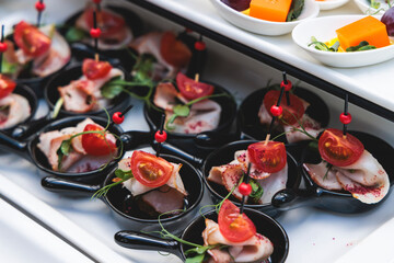 Decorated catering table buffet, banquet with variety of different gourmet exquisite food snacks...