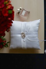 wedding rings on a pillow and bouquet