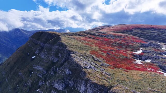 Scenic flight over colorful autumn mountain ridge wit red grass