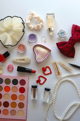 Various accessories and beauty products on white background. Coquette aesthetic. Flat lay.