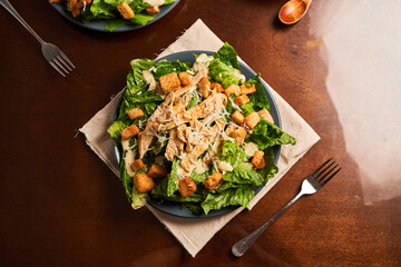 Caesar salad with shredded chicken, croutons and parmesan