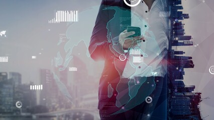 A businessman stands with a smartphone in hand, surrounded by digital data visualization and global connections over an urban cityscape, symbolizing modern finance and technology. Xenic