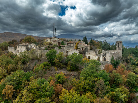 Aerial view of Castello medieval Borgo in Italy L'Aquila region with castle ruins, town gate autumn colorful folliage