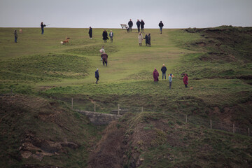 group of people walking in field  in the UK