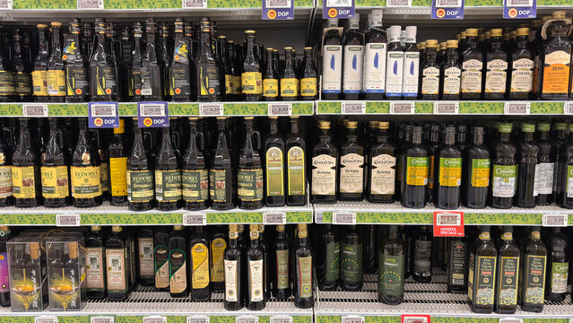 various brands of extra virgin olive oil arranged on the supermarket shelf. Udine, Italy. January 21, 2026