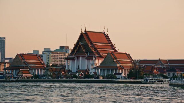 Magnificent buddhist Kalayanamit temple stands on Chao Phraya river bank. Beautiful traditional architecture in modern metropolis of Bangkok