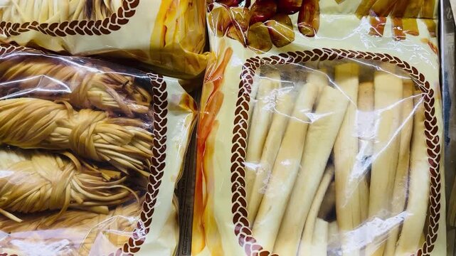 Smoked Braided Chechil Cheese In Packaging, Rope Like Golden Strands Vacuum Sealed In Clear Plastic, Ready For Retail Or Bar Counter Sale, Smoky Aroma Suggestion, Artisanal Snack Paired