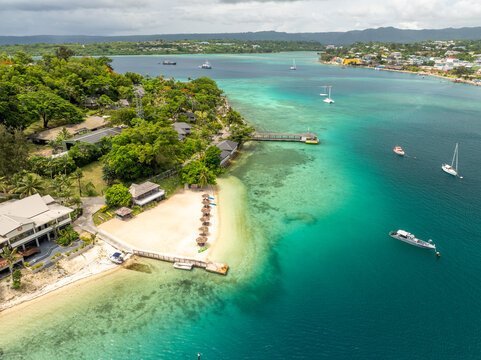 Aerial view of the turquoise waters meeting the sandy beach near Iririki Island with boats sailing, Port Vila, Shefa Province, Vanuatu.