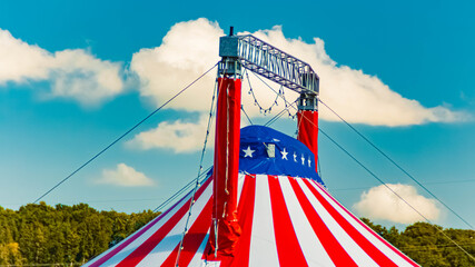 Summer landscape view with a red, white and blue circus tent at Tuntenhausen, Rosenheim, Bavaria, Germany