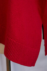 Knit red wool sweater on a mannequin