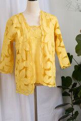 Yellow floral lace shirt and jacket pair on a mannequin