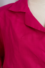 Pink belted dress in 1980s style on a mannequin