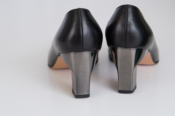 Metallic and leather shoe on a white background