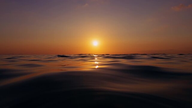 Low Angle View Of Calm Sea Surface At Sunset With Gentle Ripples And Golden Sun Reflection In Slow Motion Creating Sense Of Time Passing And Quiet Continuation