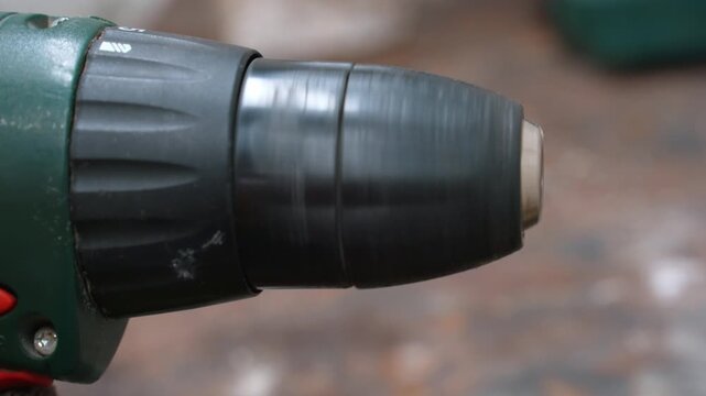 Extreme close-up of a rapidly rotating screwdriver chuck during operation. Professional Power Tool Used For Construction, Carpentry And Home Repair, Ready To Go