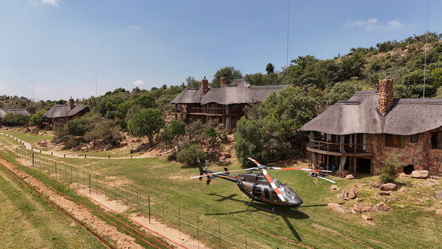 Aerial view of helicopter beside luxury lodge architecture in natural landscape, Vaalwater, Limpopo, South Africa