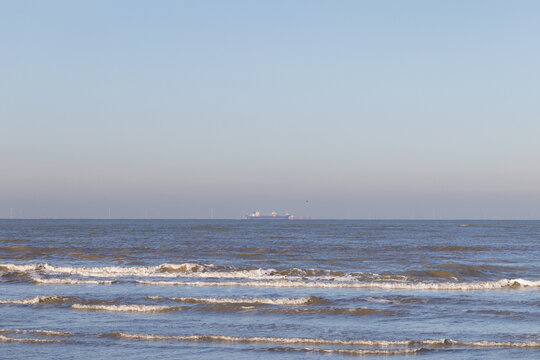 A big cargo ship on the horizon on the North Sea