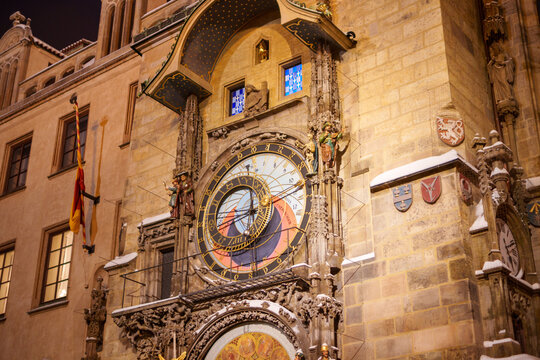 Snowy Prague Astronomical Clock glowing at night