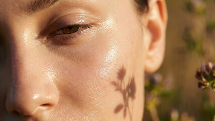 Serum application process nature setting floral elements close-up view skincare concept with bakuchiol serum