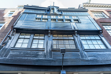 Old Wooden Building Facade with Windows in Amsterdam. House architecture in Netherlands.