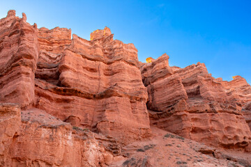 Fototapeta premium Charyn Canyon, Valley of Castles. The excellence of Kazakhstan. Panorama of natural unusual landscape. The red canyon of extraordinary beauty looks like a Martian landscape.