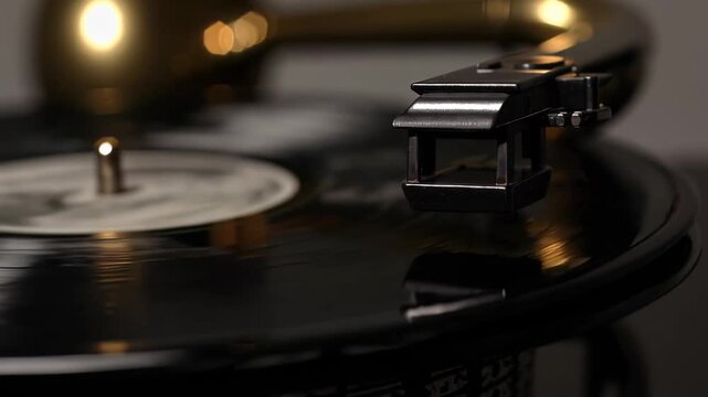 Vintage record player with a stylus positioned above a spinning vinyl record, showcasing the intricate details of the turntable and its components in a cozy setting