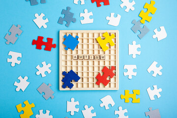 Autism Awareness Day, World Autism Day, April 2. Colorful and White Puzzles on Blue Background