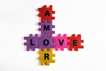 Creative composition of the word love in English and Spanish, using toy letters.