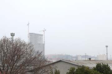Snow falling on contemporary buildings in Split, Croatia.