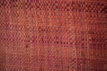 Fototapeta premium Red pink woven raffia straw texture background