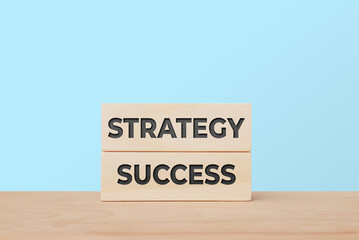 Strategy Success Concept with Wooden Blocks on Light Blue Background for Growth