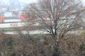Snow falling on the industrial zone. Selective focus.