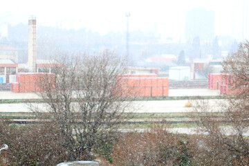 Snow falling on the industrial zone. Selective focus.