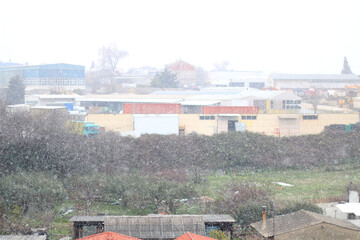 Snow falling on the industrial zone. Selective focus.