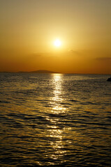 Obraz premium Summer sunset over the Adriatic Sea in shiny yellow colors