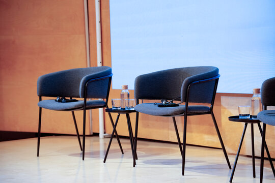 Conference stage chairs ready for panel discussion event