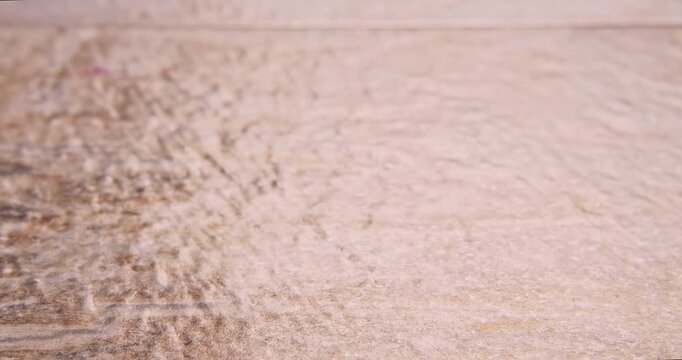 Front view of low speed falling pumpkin seeds (Pepitoria), on a natural surface.