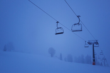 apres ski - view of the switched off cable car in the night snowstorm